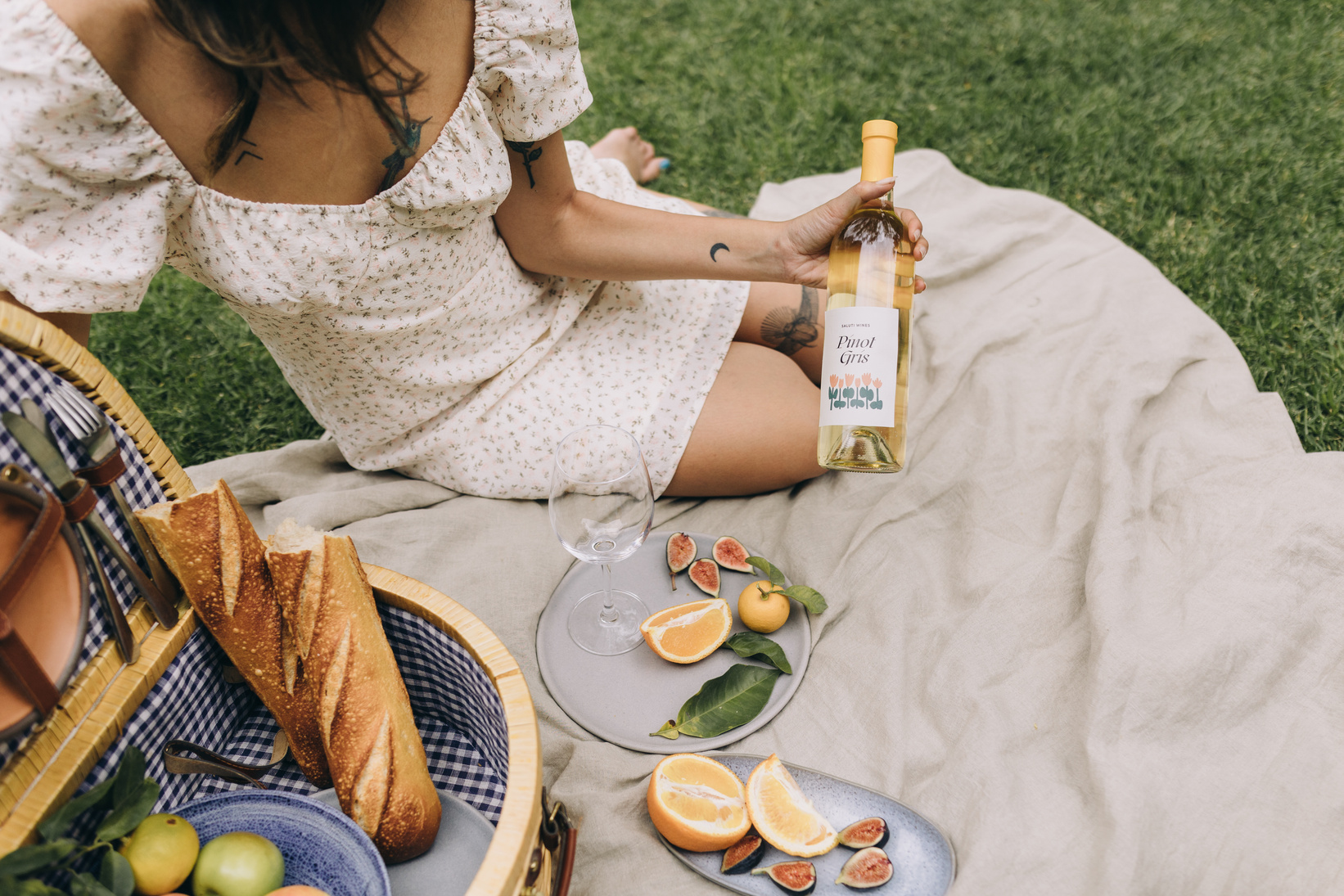 Woman with Bottle of Wine on a Picnic